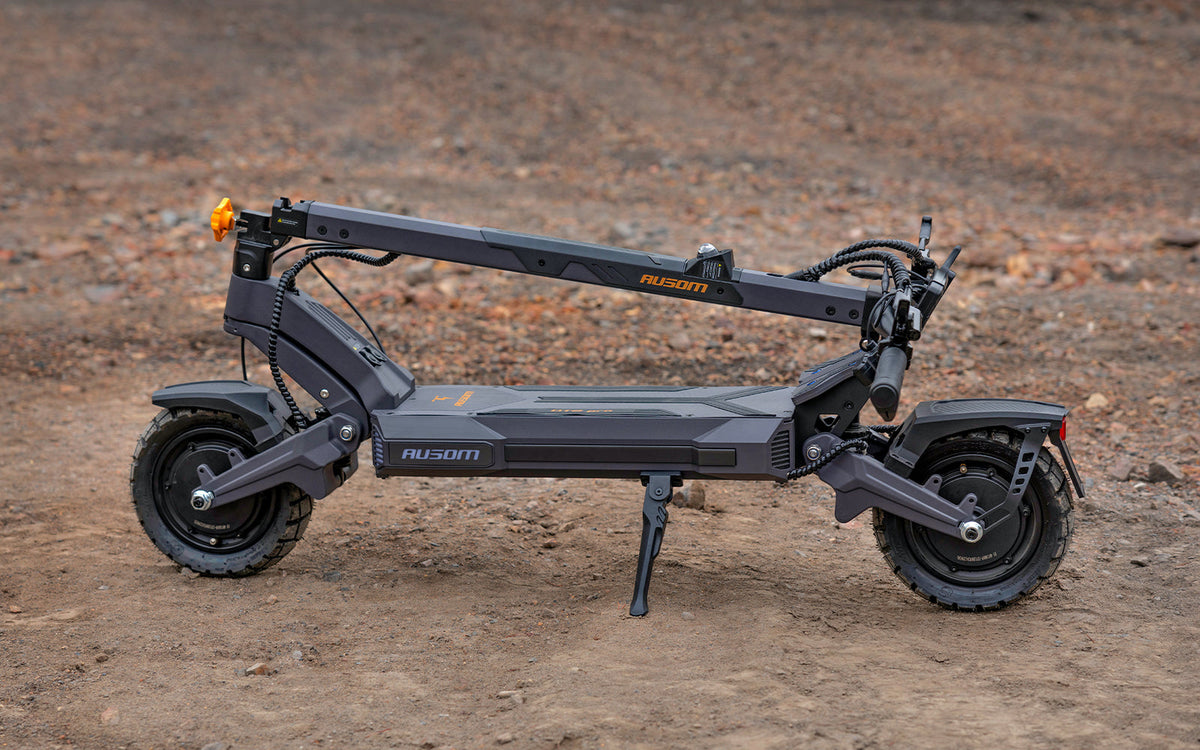 Black electric scooter on a dirt surface