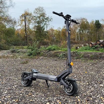 Electric scooter on a gravel path with trees in the background